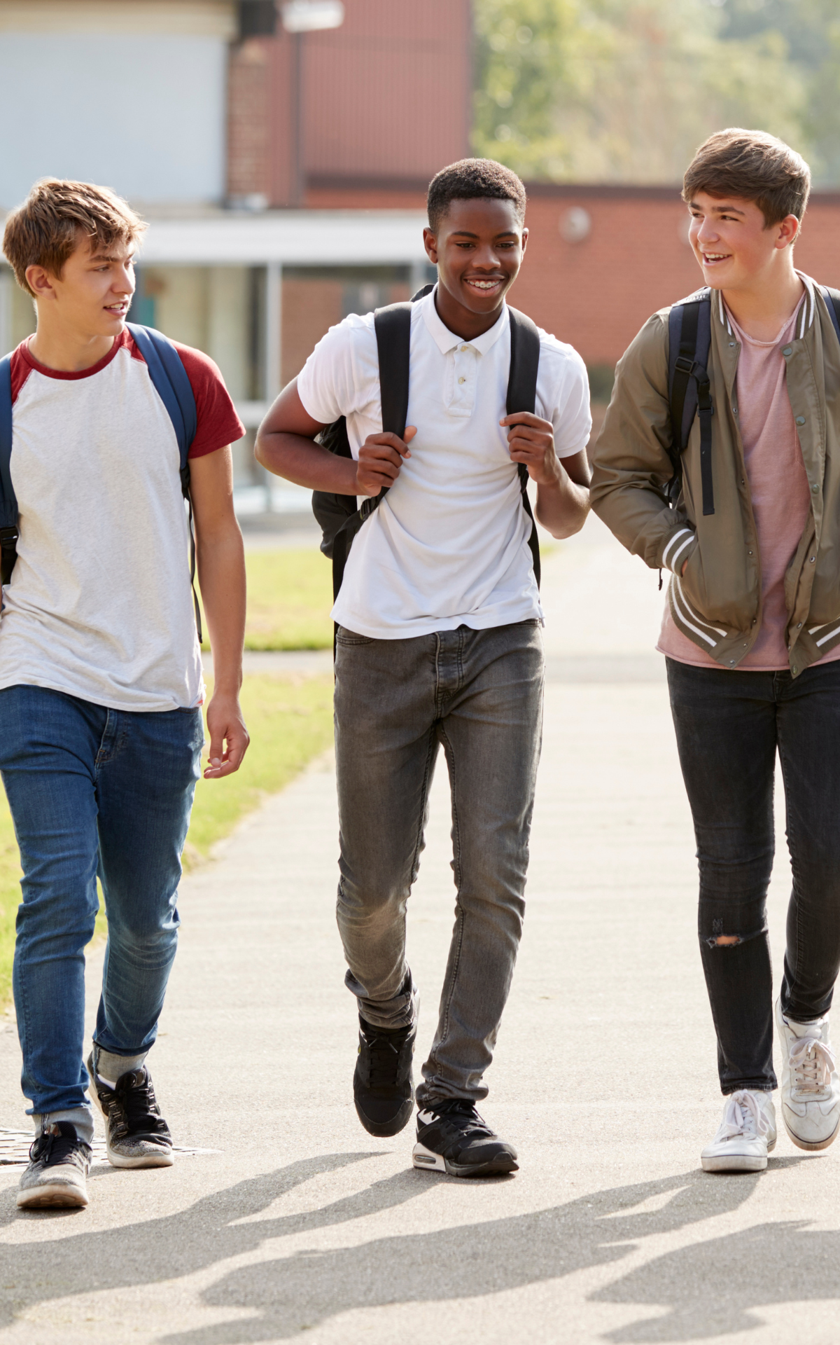 three students walk to school